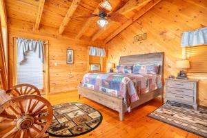 a bedroom with a bed in a log cabin at Change of Attitude By Avada Properties in Sevierville