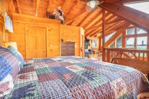a bedroom with a bed in a wooden cabin at Change of Attitude By Avada Properties in Sevierville