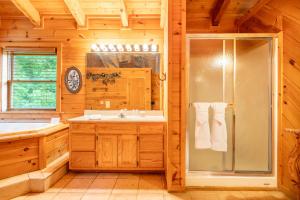 a bathroom with a shower and a sink at Change of Attitude By Avada Properties in Sevierville +35 photos