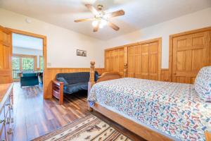 a bedroom with a bed and a ceiling fan at Change of Attitude By Avada Properties in Sevierville