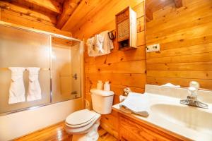 a bathroom with a toilet and a sink and a shower at Change of Attitude By Avada Properties in Sevierville