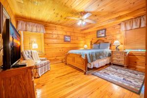 a bedroom with a bed in a log cabin at Change of Attitude By Avada Properties in Sevierville