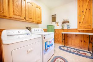 a laundry room with a washer and dryer at Change of Attitude By Avada Properties in Sevierville