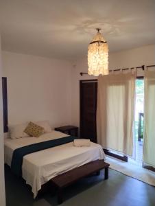 a bedroom with two beds and a chandelier at Villa Piauí in Barra Grande +16 photos