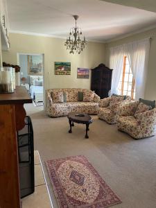 a living room with a couch and a table in it at Boschberg Cottage in Somerset East
