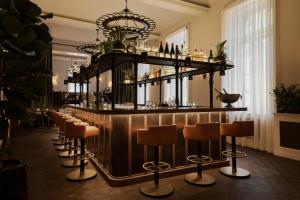 a bar with a row of bar stools at Sir Prague, part of Sircle Collection in Prague