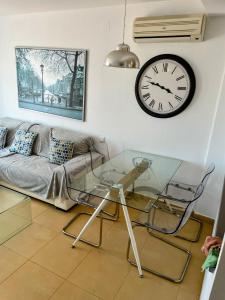 a living room with a glass table and a clock at Casa Enda - Blue Sky Property Management in Fuensalida