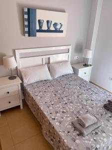 a bedroom with a bed with two night stands and two lamps at Casa Enda - Blue Sky Property Management in Fuensalida