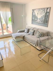 a living room with a couch and a glass table at Casa Enda - Blue Sky Property Management in Fuensalida