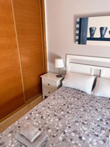 a bedroom with a bed and a wooden door at Casa Enda - Blue Sky Property Management in Fuensalida
