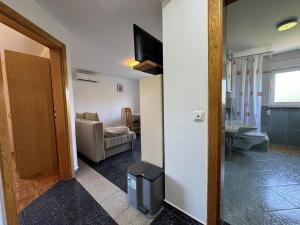 a room with a hallway with a living room at Apartments Vodopija in Soline