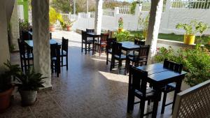 a row of tables and chairs on a patio at Hotel Posada Enilda in Providencia