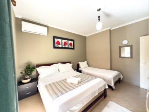 two beds in a small room with at LunaSol seaside Apartments in Durrës