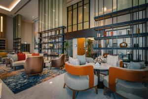 a lobby of a hotel with chairs and a table at First Grand Hotel in Dammam