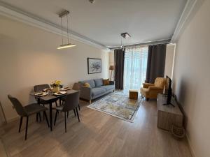 a living room with a dining table and a couch at Leona Lux Apartment Skopje in Skopje