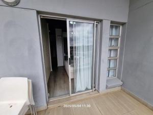 an empty room with a sliding glass door to a balcony at Genesis on Fairmount in Johannesburg +32 photos