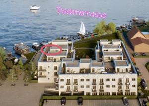 arial view of a building with a boat in the water at PenthouseNeuruppin direkt am See in Neuruppin