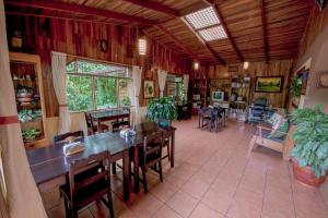 a dining room with tables and chairs in a room at Hospedaje Mariposa in Monteverde Costa Rica