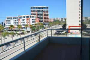 a balcony with a view of the beach and buildings at Alba Suites in Vlorë