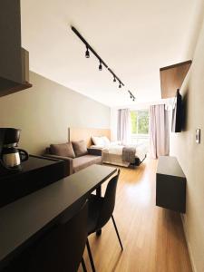 a living room with a couch and a bed at UniHome Niterói by Housi in Niterói