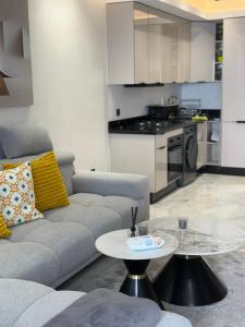 a living room with a couch and a table at Joli Studio with Seaview 16 in Casablanca