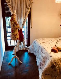 a mannequin standing next to a bed in a room at Departamento habitación doble equipado full in Cordoba