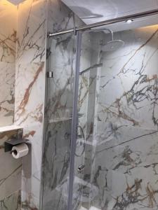 a shower with a glass door in a bathroom at Joli Studio with Seaview 16 in Casablanca +18 photos