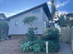 a house with a fence in front of it at SealPoint Studio in Cape St Francis