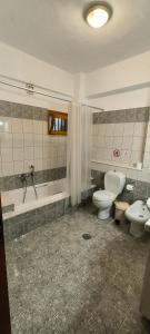 a bathroom with two toilets and a shower and a sink at Sunset Seaview Apartment in Ladochórion +27 photos