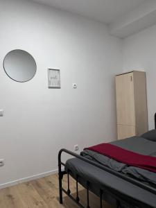 a bedroom with a bed and a mirror on the wall at ROYAL RACiNG SUiTE TOP 2 in Judenburg