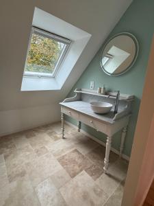 a bathroom with a sink and a mirror at Le Refuge du Tournapile - La Halte in Saint-Léger-Dubosq +10 photos