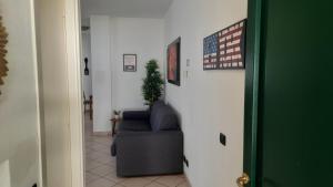 a hallway with a chair and an american flag at Villa Sara - Lake view, Garden & Private Parking in Lecco