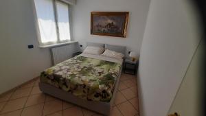 a bedroom with a bed and a picture on the wall at Villa Sara - Lake view, Garden & Private Parking in Lecco