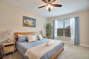a bedroom with a bed and a ceiling fan at SeaBreeze On David in Shalimar