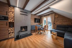 a living room with a couch and a fireplace at Wellness apartmány BARTH Holiday in Dolní Morava
