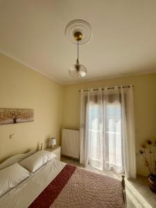 a bedroom with a bed and a large window at Agapi's Nest in Petra