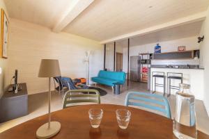 a room with a table and chairs and a kitchen at The Casalo in Finale Ligure