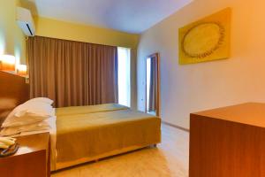 Säng eller sängar i ett rum på Rodian Gallery Hotel Apartments
