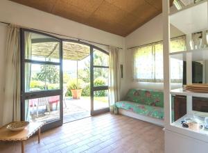 a living room with a couch and a sliding glass door at Sweet tuscany Villa for 6 to 8 people near the sea in Capalbio