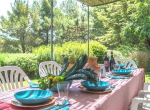 a table with blue plates and a plant on it at Sweet tuscany Villa for 6 to 8 people near the sea in Capalbio