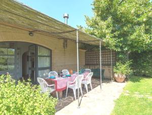 a table and chairs sitting on a patio at Sweet tuscany Villa for 6 to 8 people near the sea in Capalbio