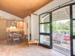 a kitchen and dining room with a table and a large window at Sweet tuscany Villa for 6 to 8 people near the sea in Capalbio +35 photos