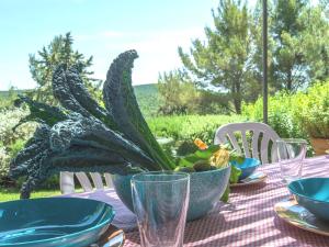 a table with plates and bowls of food on it at Sweet tuscany Villa for 6 to 8 people near the sea in Capalbio