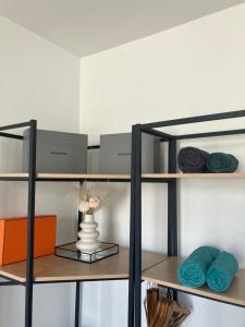 een plank met handdoeken en een vaas erop bij Charmant studio calme, proche La Défense & Paris in La Garenne-Colombes