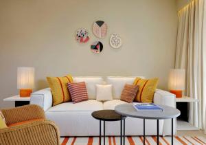 a living room with a white couch and a table at The Westin Resort, Costa Navarino in Romanu