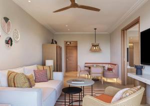 a living room with a couch and a table at The Westin Resort, Costa Navarino in Romanu