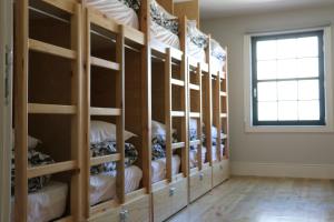 a room filled with wooden shelves with white towels at Nice Way Porto Hostel in Porto