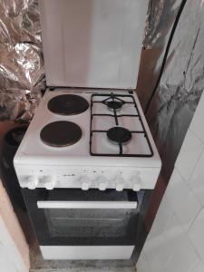 a white stove top oven in a kitchen at Къща за гости Снежа/ Guest house Snezha in Obzor