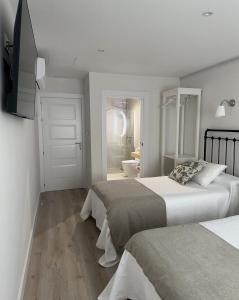 Ein Bett oder Betten in einem Zimmer der Unterkunft Cantábrico Fonsagrada