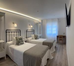 Ein Bett oder Betten in einem Zimmer der Unterkunft Cantábrico Fonsagrada